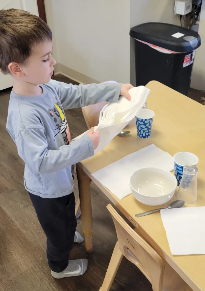 A child prepares food at Creative Gardens