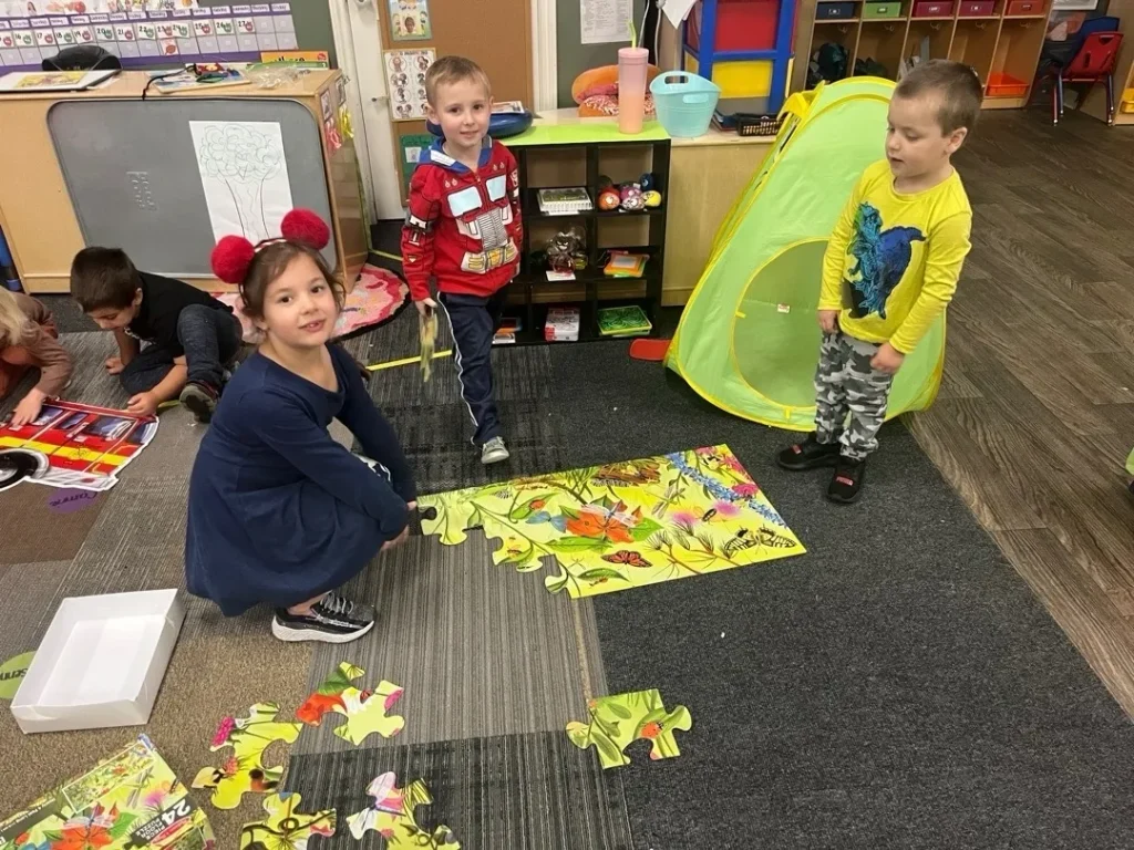 Children work on a play puzzle at Learning Tree