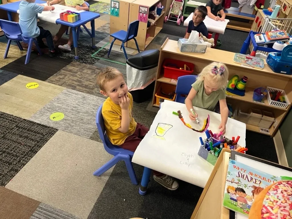 Children draw with markers at Learning Tree