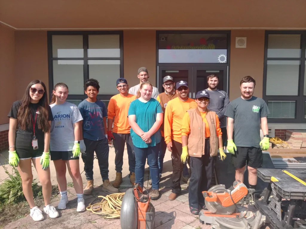 AmeriCorps members pose during a construction project